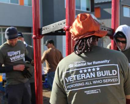 Image of veterans assembling a metal playground structure